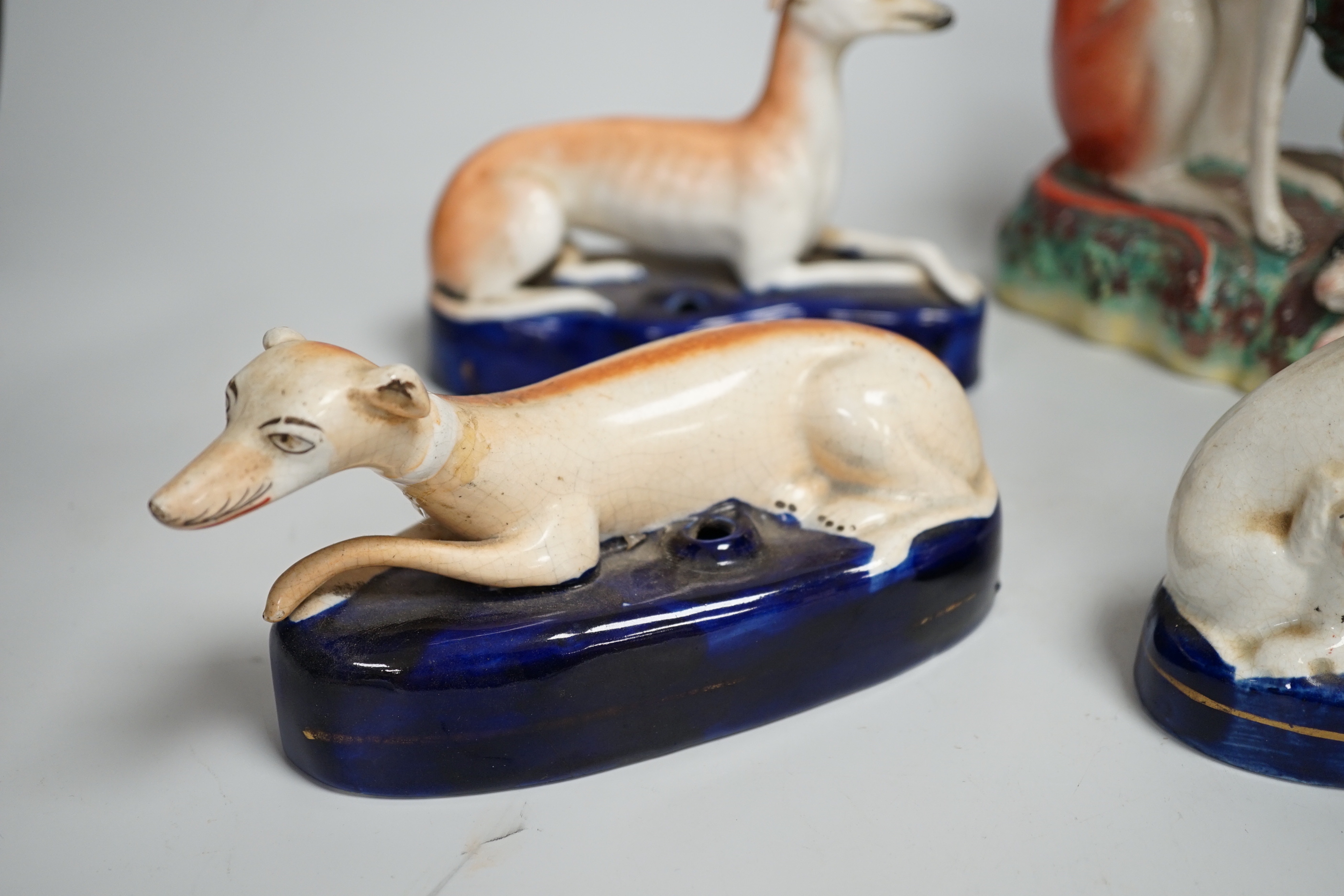 Four Staffordshire dogs including greyhounds and a spaniel, the largest 29cm high